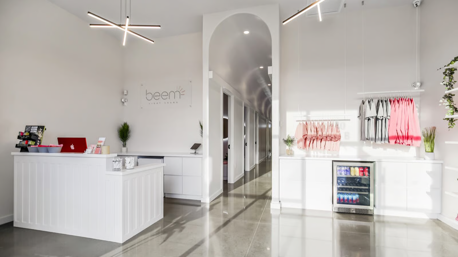 Beem Light Sauna studio lobby with front desk, retail area, and doorway leading to treatment rooms