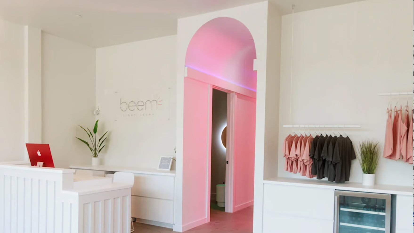 Beem Light Sauna lobby with front desk, retail rack, and doorway leading to treatment areas